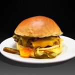 Hamburguesa Mexicana, Bacon crujiente, doble queso cheedar, chile, mahonesa de chipotle, guacamole y pepinillo